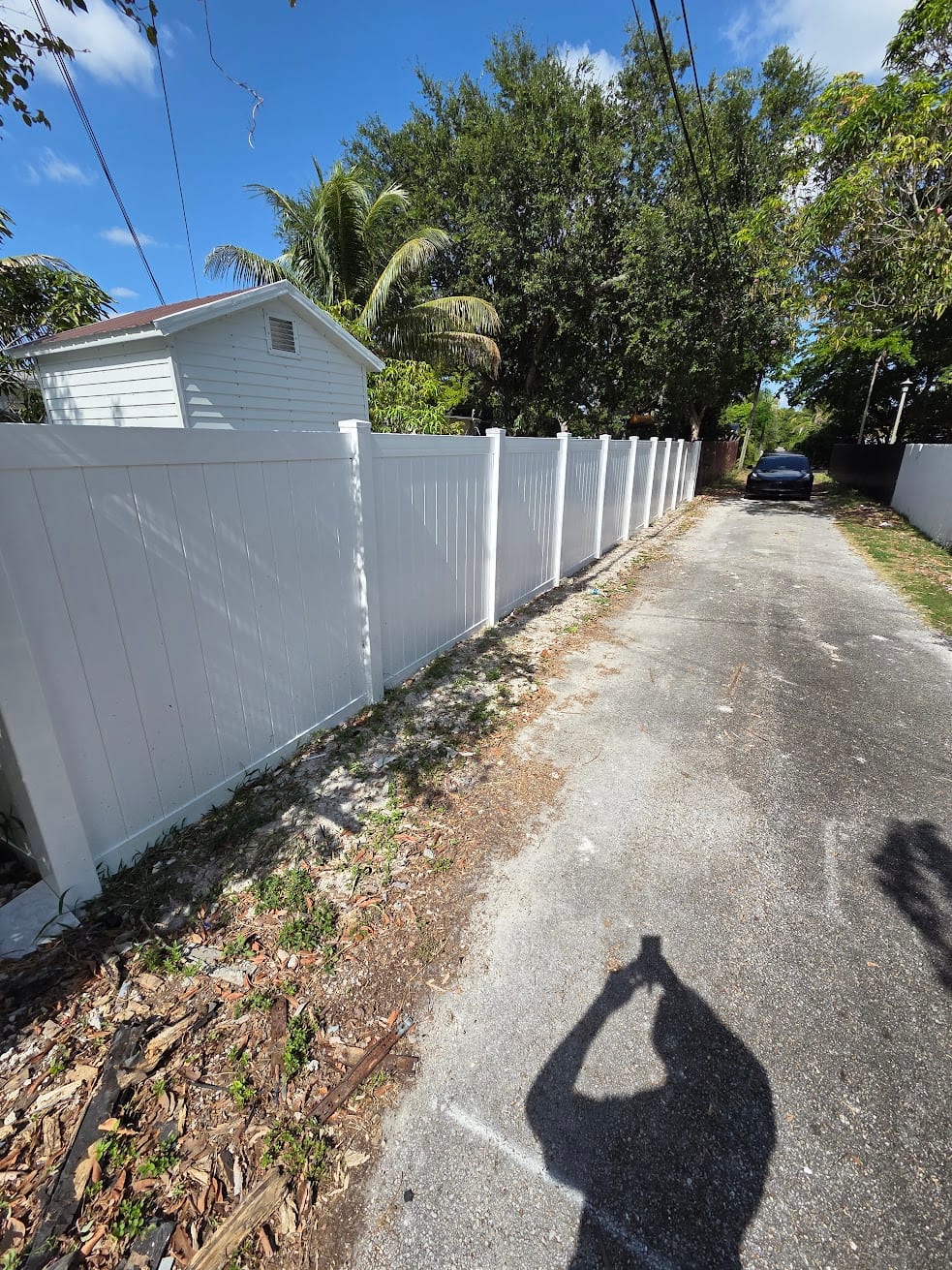 Completed white vinyl privacy fence installation in Hollywood, Florida
